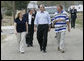 President George W. Bush walks with Cheryl and Ernie Woodard through their Long Beach, Miss., neighborhood Thursday, March 1, 2007, during the President’s tour of the neighborhood where some homes, including the Woodward's, damaged by Hurricane Katrina have been rebuilt with Gulf Coast grant money. White House photo by Eric Draper