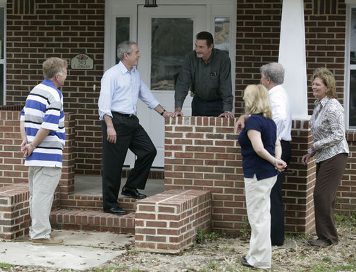 President George W. Bush is joined by Ernie Woodward of Long Beach, Miss., left, as he talks with Wendell Orr, center, a contractor, during the President’s tour Thursday, March 1, 2007, into a neighborhood where some homes damaged by Hurricane Katrina have been rebuilt with Gulf Coast grant money. White House photo by Eric Draper