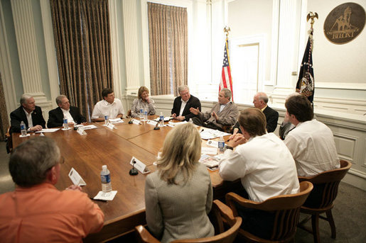President George W. Bush is joined by Mississippi Governor Haley Barbour, left, and Biloxi, Miss., Mayor A. J. Holloway, right, during a meeting with local leaders Thursday, March 1, 2007 in Biloxi, on the recovery and reconstruction efforts underway in the region devastated by Hurricane Katrina. White House photo by Eric Draper