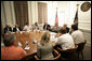 President George W. Bush is joined by Mississippi Governor Haley Barbour, left, and Biloxi, Miss., Mayor A. J. Holloway, right, during a meeting with local leaders Thursday, March 1, 2007 in Biloxi, on the recovery and reconstruction efforts underway in the region devastated by Hurricane Katrina. White House photo by Eric Draper