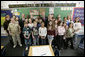 President George W. Bush is joined by Indiana Gov. Mitch Daniels, center, and Indiana Congressman Baron Hill, at left, as they pose for a photo with students and teachers Teri Sanders and Tammy Persinger in the fifth grade U.S. History class at the Silver Street Elementary School in New Albany, Ind., Friday, March 2, 2007.  White House photo by Eric Draper