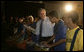 President George W. Bush joins the festivities Friday, March 9, 2007, as he plays percussion with a group of musicians after a community roundtable at Meninos do Morumbi in Sao Paulo. White House photo by Eric Draper