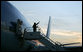 President George W. Bush and Mrs. Laura Bush are silhouetted as they wave goodbye to Sao Paulo Friday, March 9, 2007, before boarding Air Force One en route to Uruguay on their six-day, five-country, Latin American tour. White House photo by Paul Morse