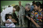 President George W. Bush and Mrs. Laura Bush play with a young girl during a visit Monday, March 12, 2007, to the Carlos Emilio Leonardo School in Santa Cruz Balanya, Guatemala. The couple visited a medical readiness and training exercise site at the school. White House photo by Eric Draper