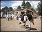 Members of the Patzun Dance group perform a cultural dance Monday, March 12, 2007, during a visit to Iximche, Guatemala, by President George W. Bush and Mrs. Laura Bush and President Oscar Berger of Guatemala and his wife, Mrs. Wendy Widmann de Berger, who look on in the background. White House photo by Paul Morse