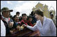 Mrs. Laura Bush reaches out to a small child during a visit Monday, March 12, 2007, to the Town Square in Santa Cruz Balanya, Guatemala. White House photo by Eric Draper