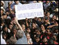 A sign welcoming President George W. Bush is held up by the crowd as the President waves upon his arrival Monday, March 12, 2007, to the Town Square of Santa Cruz Balanya, Guatemala. The President and Mrs. Laura Bush spent the morning in the town and other nearby towns before heading on to Mexico in the final leg of their five-country to Central and South America visit. White House photo by Paul Morse