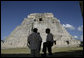President George W. Bush is silhouetted as he pauses with President Felipe Calderon of Mexico and an interpreter during their tour Tuesday, March 13, 2007, of the Mayan ruins of Uxmal. White House photo by Eric Draper