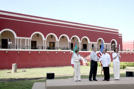 President George W. Bush and Mrs. Laura Bush are greeted onstage at Hacienda Temozon by President Felipe Calderon and Mrs. Margarita Zavala during arrival ceremonies Tuesday, March 13, 2007, in Temozon Sur, Mexico. White House photo by Paul Morse
