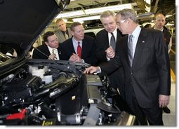 President George W. Bush takes a look under a hood during his tour Tuesday, March 20, 2007, of the Ford Motor Company - Kansas City Assembly Plant in Claycomo, Missouri, joined by, from left, U.S. Rep. Sam Graves, Ford President and CEO Alan Mulally and Ford Group Vice President Derrick Kuzak.  White House photo by Eric Draper