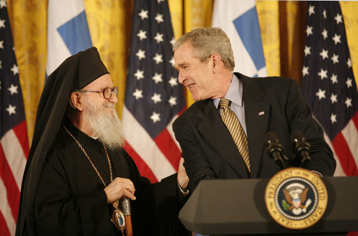 President George W. Bush smiles as he welcomes His Eminence Archbishop Demetrios to the White House Friday, March 23, 2007, to celebrate Greek Independence Day and to recognize the contributions of Greek-Americans to American culture. This year's ceremony also recognized the 40th anniversary of the episcopacy of the Archbishop. White House photo by Eric Draper
