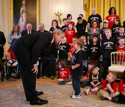 President George W. Bush speaks with one of the children who is a member of the Children’s Miracle Network Champions in the East Room of the White House, Thursday, March 29, 2007, where President Bush honored the CMN organization for their work in helping save and improve the lives of children with severe medical challenges. White House photo by Eric Draper