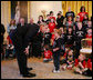 President George W. Bush speaks with one of the children who is a member of the Children’s Miracle Network Champions in the East Room of the White House, Thursday, March 29, 2007, where President Bush honored the CMN organization for their work in helping save and improve the lives of children with severe medical challenges. White House photo by Eric Draper