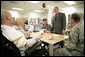 President George W. Bush talks with the Shirley family of Labelle, Fla., Friday, March 30, 2007, during a visit to Walter Reed Army Medical Center in Washington, D.C. Pictured, from left, is U.S. Army Sgt. Luke Shirley, his mother Bonniesue Whitehead, his brother Joshua James Shirley, who is a Specialist in the U.S. Army, and an unidentified hospital staff member. White House photo by Eric Draper