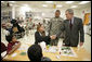 President George W. Bush meets with the family of Sgt. William Enriquez Santos of Carolina, Puerto Rico, Friday, March 30, 2007, during a visit to Walter Reed Army Medical Center in Washington, D.C. Pictured from left are Sgt. Santos’ sons, Josh, 8 and John, 17, and his wife Betsy Rodriguez. White House photo by Eric Draper