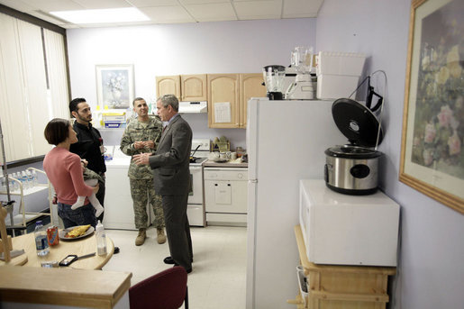 President George W. Bush talks with U.S. Army Spc. Craig Anthony Chavez of Victorville, Calif., and his wife Ariana Elise Chavez and their 7-month-old daughter Jailyn Alexandra Chavez Friday, March 30, 2007, during a visit to Walter Reed Army Medical Center in Washington, D.C. White House photo by Eric Draper
