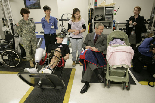 President George W. Bush peeks in at 2-month-old Hailey Yvonne Gardner while visiting with her parents U.S. Army Sgt. David Glenn Gardner and Beverly Yvonne Gardner, both of Lindon, Utah, Friday, March 30, 2007, during a visit to Walter Reed Army Medical Center in Washington, D.C. White House photo by Eric Draper