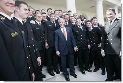 President George W. Bush meets with members of the U. S. Naval Academy football team, after presenting the team with the Commander-In-Chief trophy at the White House, Monday, April 2, 2007.  White House photo by Eric Draper