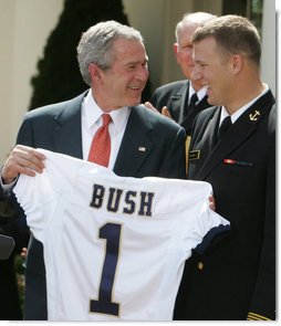 President George W. Bush accepts a jersey from co-captain Rob Caldwell of the U. S. Naval Academy football team, after President Bush presented the team with the Commander-In-Chief trophy in ceremonies in the Rose Garden at the White House, Monday, April 2, 2007. White House photo by Joyce N. Boghosian