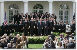President George W. Bush welcomes members the U. S. Naval Academy football team to the White House, where he presented the Commander-In-Chief trophy to the team in ceremonies in the Rose Garden at the White House, Monday, April 2, 2007. White House photo by Joyce N. Boghosian