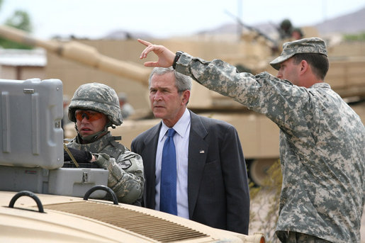 President George W. Bush watches as a soldier operates technical field equipment, joined by U.S. Army Captain Pat Armstrong, right, during President Bush’s visit to the U.S. Army National Training Center Wednesday, April 4, 2007, at Fort Irwin, Calif. White House photo by Eric Draper