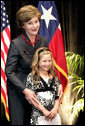 Mrs. Laura Bush hugs Rae Leigh Bradbury Wednesday, April 4, 2007, in Austin, after the 9-year-old introduced Mrs. Bush during the announcement of the future opening of the Texas Regional Office of the National Center for Missing and Exploited Children. Rae Leigh was the first child in the United States to be recovered as a result of an AMBER Alert when she was 8 weeks old in November 1998. So far AMBER Alerts have saved more than 300 young lives in the United States. White House photo by Shealah Craighead