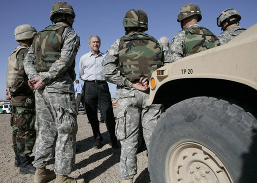 President George W. Bush stands amidst camouflaged troops Monday, April 9, 2007, during his tour of the U.S.-Mexico border in Yuma, Ariz. White House photo by Eric Draper