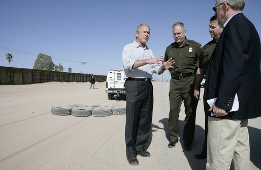 President George W. Bush emphasizes a point Monday, April 9, 2007, as he stands with Chief Border Patrol Agent Ron Colburn, center, and others during a tour of the U.S.-Mexico border in Yuma, Ariz. White House photo by Eric Draper