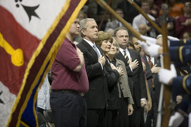 President George W. Bush and Mrs. Laura Bush stand with a hand over their hearts during the Convocation Tuesday, April 17, 2007, in Blacksburg, Va., in honor of the Virginia Tech shooting victims. Virginia Governor Tim Kaine and his wife, Anne Holton are seen at right. White House photo by Eric Draper