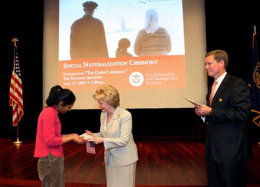 Mrs. Lynne Cheney hands out a copy of, “The Citizen’s Almanac,” during a special naturalization ceremony at the National Archives Tuesday, April 17, 2007, in Washington, D.C. 