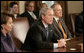 President George W. Bush talks with reporters at the start of his meeting with bicameral and bipartisan legislative leaders, including House Speaker Nancy Pelosi, left, and Senate Majority Leader Harry Reid, in the Cabinet Room at the White House, Wednesday, April 18, 2007. White House photo by Eric Draper
