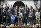 President George W. Bush is presented with a team jersey by Indianapolis Colts’ quarterback Peyton Manning, left, and head coach Tony Dungy during a ceremony honoring their victory in the 2007 NFL Super Bowl Monday, April 23, 2007, on the South Lawn. White House photo by Shealah Craighead