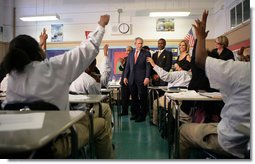 Students in the seventh grade science class at Harlem Village Academy Charter School in New York, raise their hands to answer a question posed by President George W. Bush during his visit to the school Tuesday, April 24, 2007.  White House photo by Eric Draper