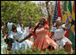 Members from the Kankouran West African Dance Company performs during a ceremony marking Malaria Awareness Day Wednesday, April 25, 2007, in the Rose Garden. White House photo by Eric Draper