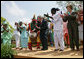 President George W. Bush and Mrs. Laura Bush take the stage with the Kankouran West African Dance Company after delivering remarks during a ceremony marking Malaria Awareness Day Wednesday, April 25, 2007, in the Rose Garden. White House photo by Eric Draper