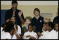Mrs. Laura Bush, joined by NBA and WNBA players, prepares to pose for photos with fifth-grade students following a basketball game during a Malaria Awareness Day event Wednesday, April 25, 2007, at the Friendship Public Charter School on the Woodridge Elementary and Middle School campus in Washington, D.C. White House photo by Shealah Craighead