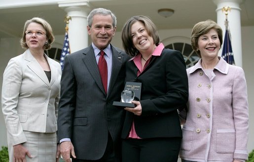 President George W. Bush is joined by Secretary of Education Margaret Spellings and Mrs. Laura Bush as they congratulate the 2007 National Teacher of the Year, Andrea Peterson, during ceremonies Thursday, April 26, 2007, in the Rose Garden. Mrs. Peterson is a music teacher at Monte Cristo Elementary School in Granite Falls, Washington. White House photo by Eric Draper