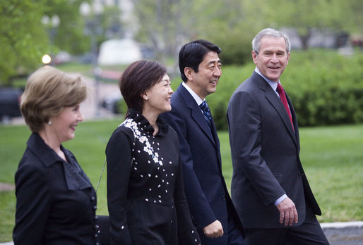 President George W. Bush and Mrs. Laura Bush walk past the press on the North Lawn with Japanese Prime Minister Shinzo Abe and his wife Mrs. Akie Abe Thursday, April 26, 2007, as they arrive for a social dinner at the White House. White House photo by Eric Draper