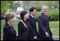President George W. Bush and Mrs. Laura Bush walk past the press on the North Lawn with Japanese Prime Minister Shinzo Abe and his wife Mrs. Akie Abe Thursday, April 26, 2007, as they arrive for a social dinner at the White House. White House photo by Eric Draper