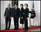 President George W. Bush and Mrs. Laura Bush stand for press photographs with Japanese Prime Minister Shinzo Abe and his wife Mrs. Akie Abe Thursday, April 26, 2007, as they arrive at the North Portico for a social dinner at the White House. White House photo by Eric Draper