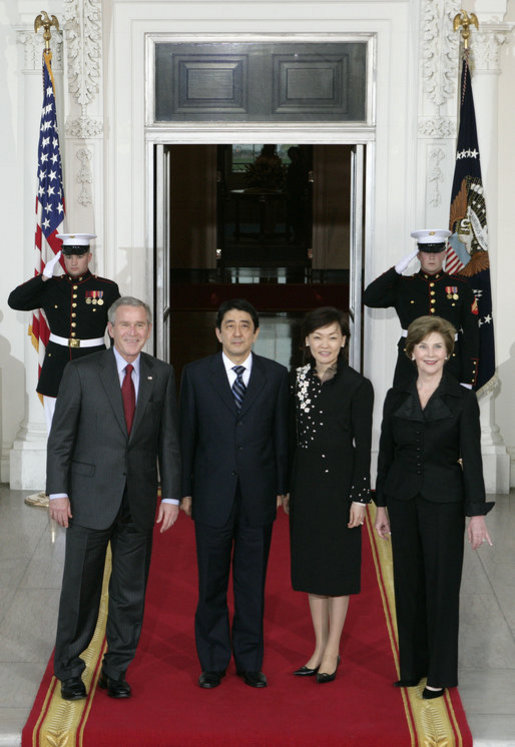 President George W. Bush and Mrs. Laura Bush stand for press photographs with Japanese Prime Minister Shinzo Abe and his wife Mrs. Akie Abe Thursday, April 26, 2007, as they arrive at the North Portico for a social dinner at the White House. White House photo by Shealah Craighead