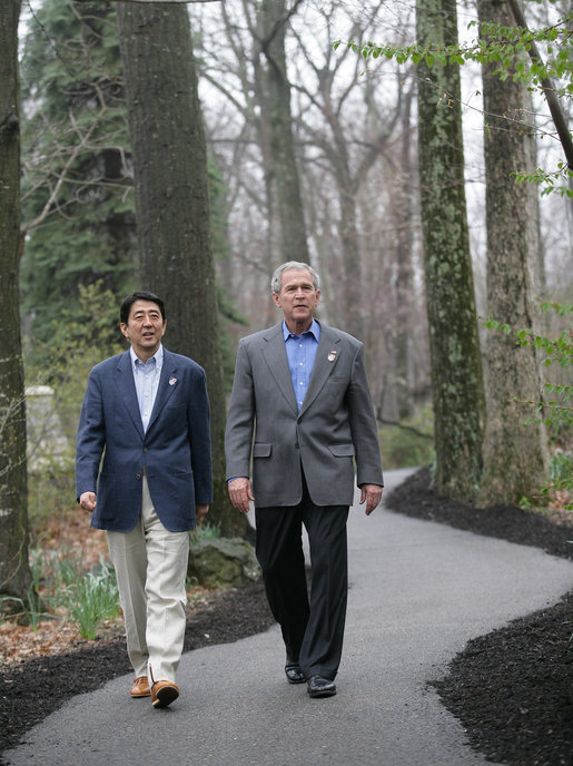 President George W. Bush walks with Prime Minister Shinzo Abe during their meeting Friday, April 27, 2007, at Camp David. Said the President, " We talked about the fact that our alliance -- and it is a global alliance -- is rooted in common values, especially our commitment to freedom and democracy." White House photo by Eric Draper
