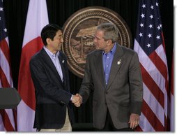 President George W. Bush exchanges handshakes with Prime Minister Shinzo Abe of Japan after their joint press availability Friday, April 27, 2007, at Camp David.  White House photo by Joyce Boghosian