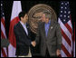 President George W. Bush exchanges handshakes with Prime Minister Shinzo Abe of Japan after their joint press availability Friday, April 27, 2007, at Camp David. White House photo by Joyce Boghosian