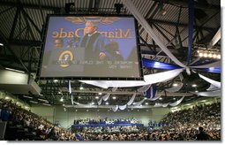 President George W. Bush is shown at the podium in an overhead screen Saturday, April 28, 2007, as he stands onstage at Miami Dade College - Kendall Campus in Miami and delivers the 2007 commencement address. White House photo by Eric Draper