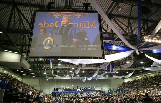 President George W. Bush is shown at the podium in an overhead screen Saturday, April 28, 2007, as he stands onstage at Miami Dade College - Kendall Campus in Miami and delivers the 2007 commencement address. White House photo by Eric Draper