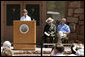 Mrs. Laura Bush speaks to a crowd of about 160 people Sunday, April 29, 2007, during the rededication ceremony of the Zion National Park Nature Center in Springdale, Utah. Interior Secretary Dirk Kempthorne is pictured at the far right. Designed by Gilbert Stanley Underwood in 1934, the center was renovated with new insulation, updated exterior side paneling and restrooms. White House photo by Shealah Craighead