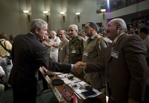 President George W. Bush reaches out to Mr. Shahib Hamad Adnan, Director of Policy and Requirements for the Iraq Defense Department, after delivering remarks Tuesday, May 1, 2007, to the CENTCOM Coalition Conference at MacDill Air Force Base in Tampa. With them are, from left: Mr. Mowaffak Al Rubaie, Iraqi National Security Advisor; Lt. General Yacoob Abdul-rizzaq, Deputy Chief of Staff for Iraq Joint Forces; and Major General Abdul Hasan Mohsen, Director General of Directorate of Border Enforcement. White House photo by Eric Draper