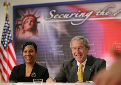 President George W. Bush is joined by Ana Karym, left, of Hyattsville, Md., a volunteer English as a Second Language teacher, during a meeting Thursday, May 3, 2007 on immigration and assimilation at the Asamblea de Iglesias Cristianas, Centro Evangelistico in Washington, D.C. White House photo by Eric Draper