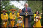 President George W. Bush welcomes guests to the Rose Garden at the White House Friday, May 4, 2007, to celebrate Cinco de Mayo and recognize the contributions of Mexican Americans. Members of the band Los Hermanos Mora Arriaga, who performed at the ceremony, are seen in background.  White House photo by Eric Draper